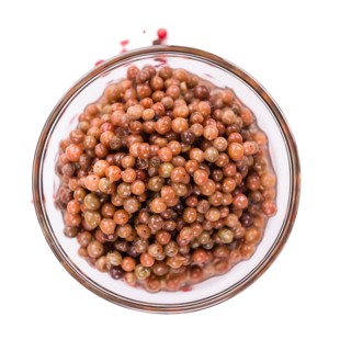 Preserved Pink Peppercorns isolated on white background, selective focus, close-up shot