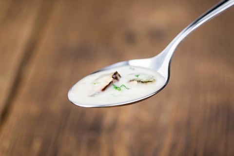 Homemade Porcini Soup on vintage background selective focus, close-up shot
