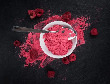 Fresh made Raspberry powder on a vintage background as detailed close-up shot