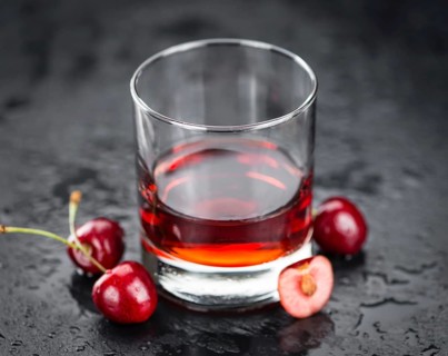 Some Cherry Liqueur on a slate slab as detailed close-up shot, selective focus