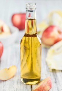 Fresh made Apple Cider on a vintage background (close-up shot)