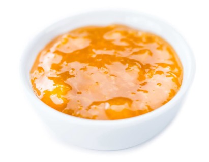 Portion of fresh made Apricot Jam isolated on white background