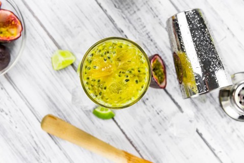 Vintage wooden table with Jorge Amado Cocktail (selective focus, close-up shot)