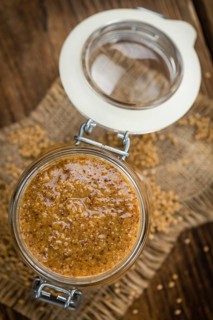 Homemade Sweet Mustard on an wooden table (selective focus) as detailed close-up shot