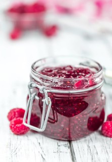 Fresh made Raspberry Jam on a vintage background as detailed close-up shot