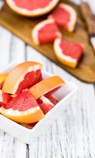 Chopped Grapefruits (selective focus) on a vintage background as detailed close-up shot