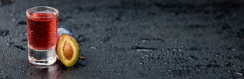 Plum Liqueur on a vintage slate slab as detailed close-up shot, selective focus