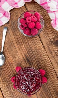 Fresh made Raspberry Jam on a vintage background as detailed close-up shot