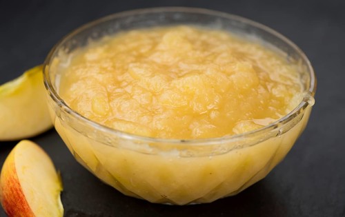Homemade Applesauce (selective focus, close-up shot) on vintage background with some fresh fruits