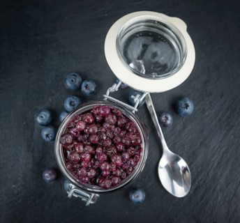 Canned Blueberries on a vintage slate slab as detailed close-up shot, selective focus
