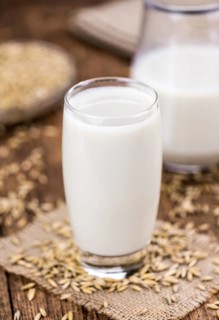 Wooden table with Oat Milk (detailed close-up shot, selective focus)
