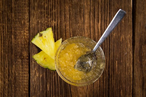 Fresh made Pineapple Jam on an old and rustic wooden table, selective focus, close-up shot