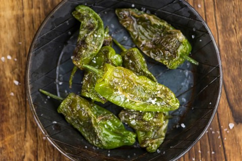 Portion of fresh Pimientos de Padron close-up shot, selective focus