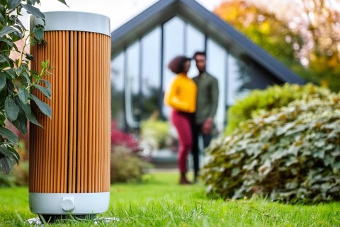 Modern air purifier in a garden, blurred view of a couple in the background, AI generated, AI