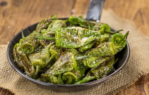 Pimientos de Padron on a vintage background as detailed close-up shot, selective focus