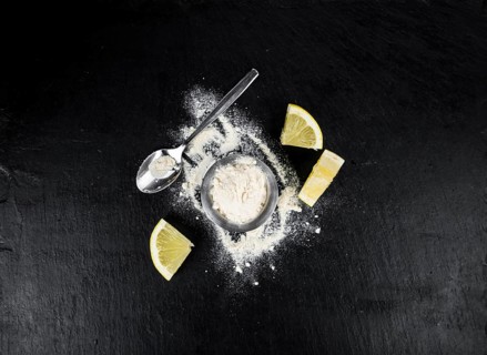 Portion of healthy Lemon powder on a slate slab (selective focus)