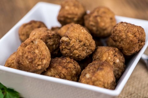 Some fresh made Meatballs on wooden background (selective focus, close-up shot)