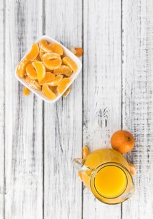 Portion of fresh made Tangerine Juice (close-up shot, selective focus)