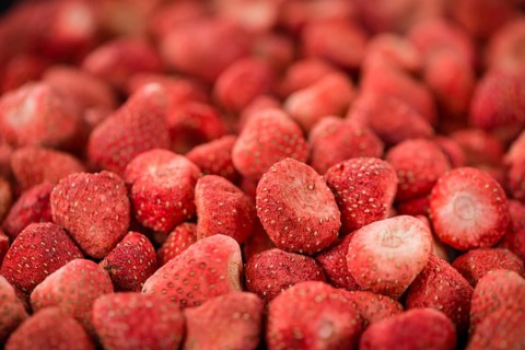 Dried Strawberries on rustic wooden background as close-up shot