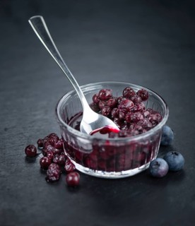 Some fresh Preserved Blueberries on a vintage slate slab, selective focus, close-up shot
