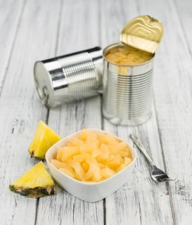 Preserved Pineapple pieces on a vintage background as detailed close-up shot, selective focus