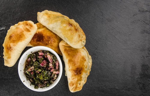 Healthy Empanadas on a vintage slate slab (close-up shot, selective focus)