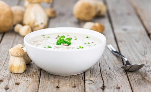 Homemade Porcini Soup on vintage background selective focus, close-up shot
