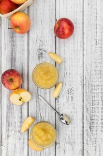 Old wooden table with fresh made Applesauce (selective focus, close-up shot)