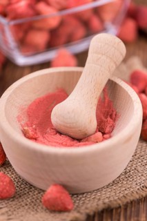 Fresh made Strawberry powder on a vintage background as detailed close-up shot