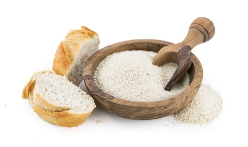 Bread Crumbs isolated on white background (selective focus, close-up shot)