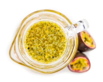 Maracuja Juice isolated on white background (selective focus, close-up shot)
