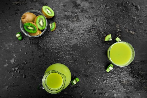 Kiwi Smoothie (selective focus) on an old and vintage background (homemade)