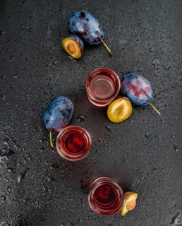 Plum Liqueur on a vintage slate slab as detailed close-up shot, selective focus