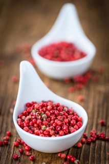 Pink Peppercorns on a vintage background as detailed close-up shot, selective focus