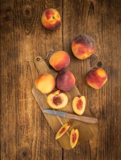Peaches on a vintage background as detailed close-up shot, selective focus