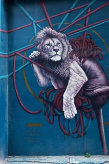 Lion hanging in ropes, mural by Greek street artist Nikolaos Tsounakas, Psirri neighbourhood,