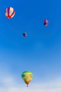 Colorful hot air balloons floating peacefully in a clear blue sky, Belarus, Minsk, Europe