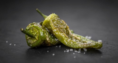 Pimientos de Padron on a vintage background as detailed close-up shot, selective focus