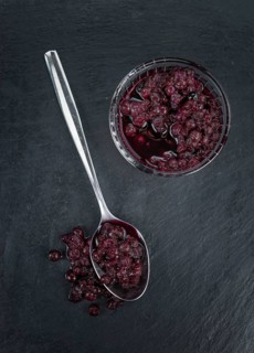 Some fresh Preserved Blueberries on a vintage slate slab, selective focus, close-up shot