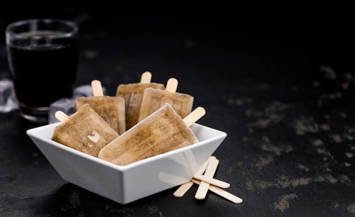 Cola Popsicles (selective focus) on a vintage background as detailed close-up shot