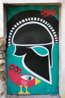 Greek helmet and bizarre bird, graffiti by street artist Uneg, Plaka historic centre, Athens,