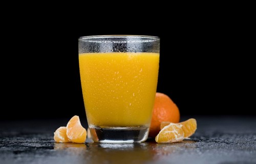 Tangerine Juice (close-up shot) on a vintage looking slate slab