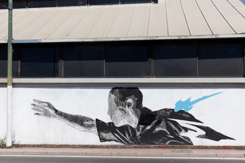 Man with outstretched arm, surreal mural in black and white by Greek street artist INO, Gazi
