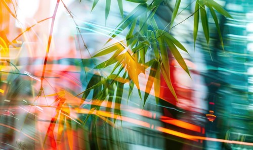 Abstract image with green bamboo leaves and vibrant orange light streaks creating a blurred effect