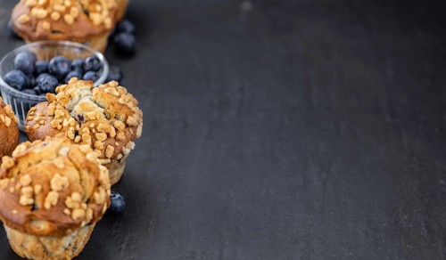 Fresh Blueberry Muffins as detailed close-up shot (selective focus)