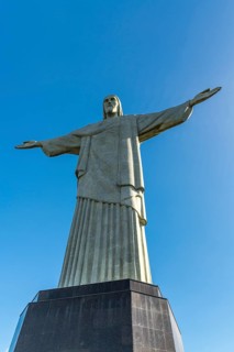 Christ the Redeemer statue in Rio de Janeiro, Brazil with blue sky in the background
