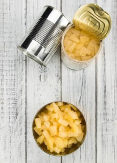 Fresh made Chopped Pineapple (preserved) on an old and rustic wooden table, selective focus,