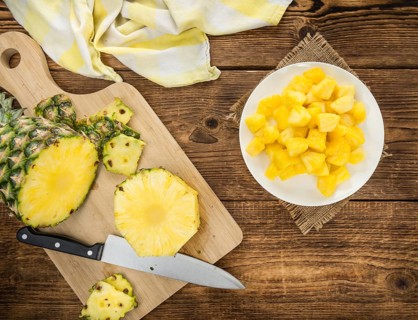 Sliced Pineapple on rustic wooden background as close-up shot