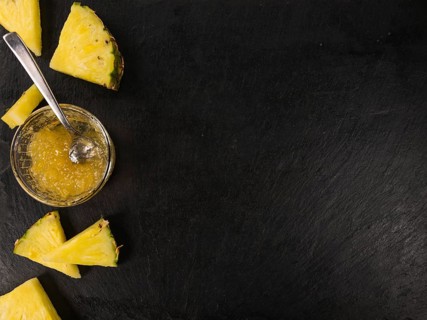 Portion of Pineapple Jam as detailed close up shot on a slate slab, selective focus