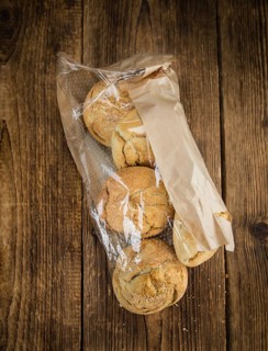 Fresh made German Buns on an old and rustic wooden table, selective focus, close-up shot